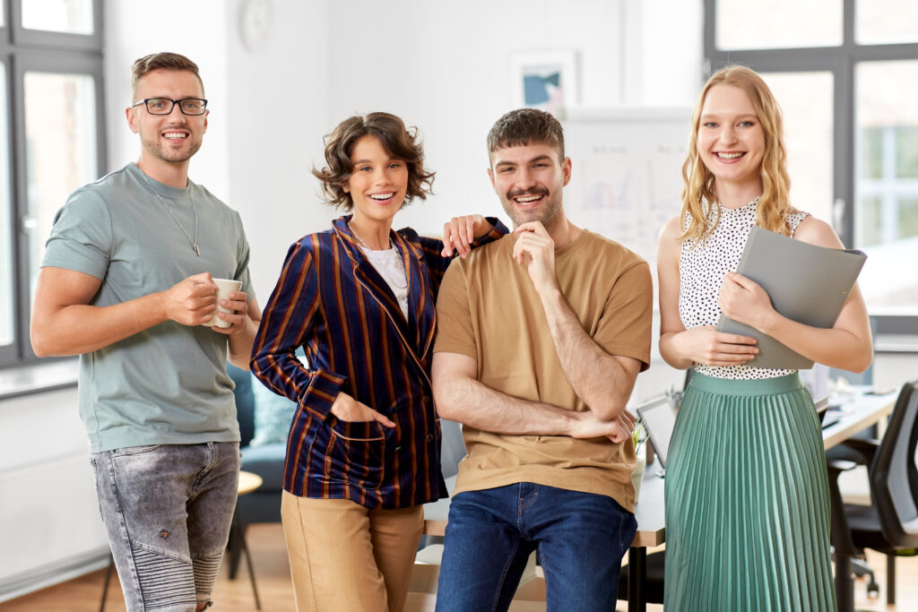 startup, corporate and people concept - happy business team at office